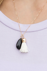 short necklace with black pendant and tassel