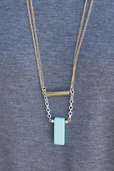 layered gold necklace with turquoise block